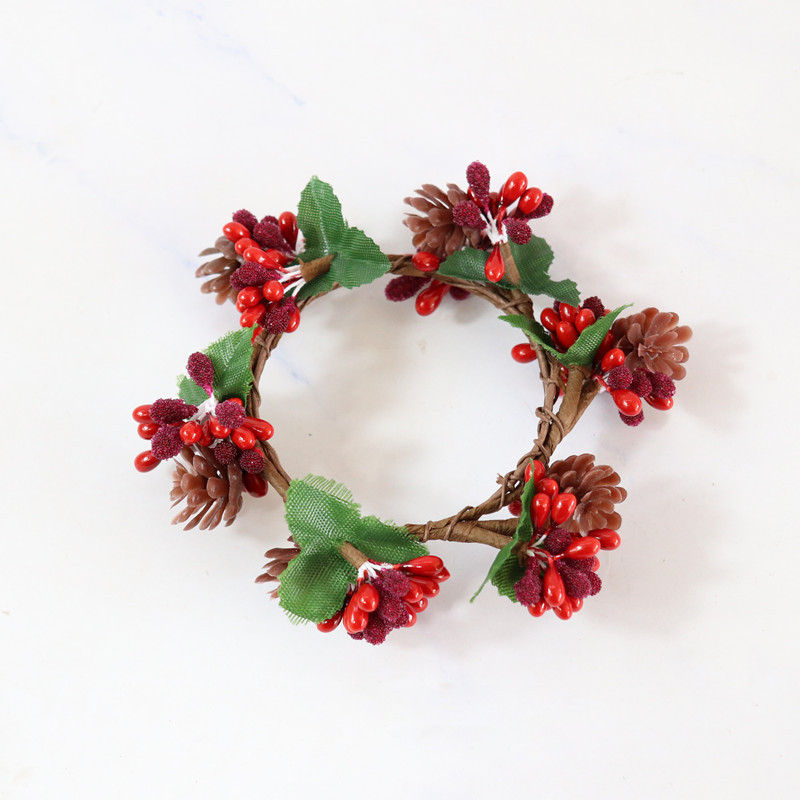 Red sand beads simulate a pine cone candle ring