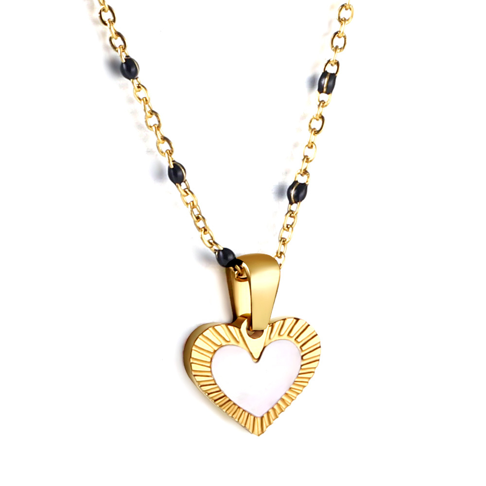 7:Heart-shaped white drop oil pendant with black beads