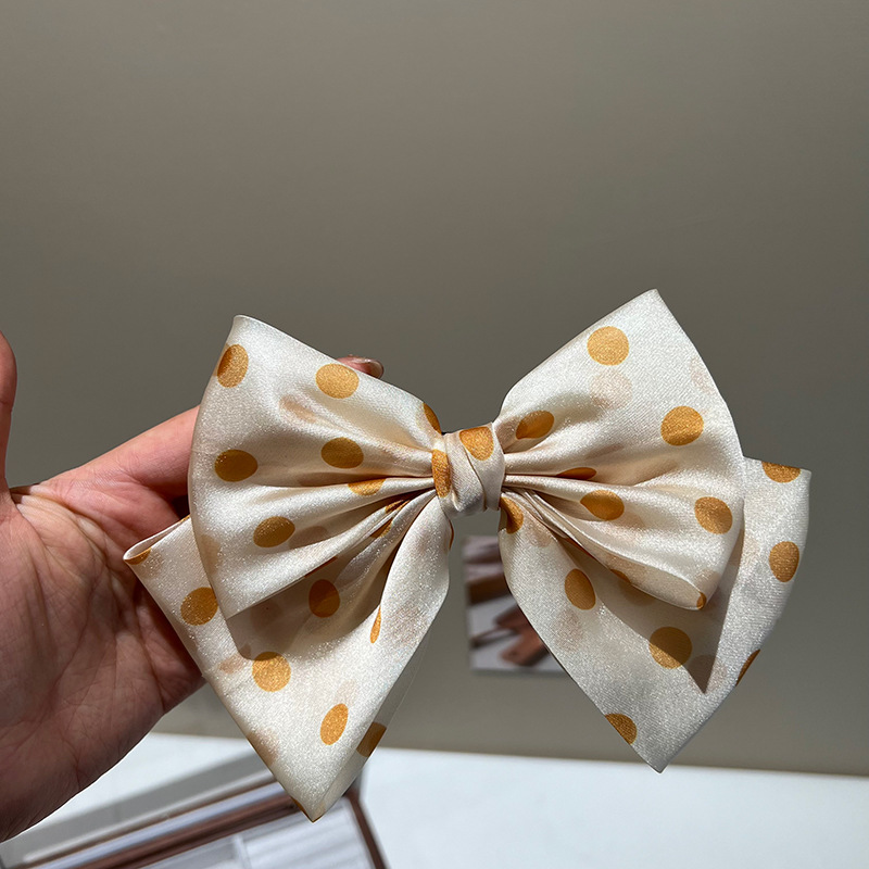 Yellow polka dot bow hair clip