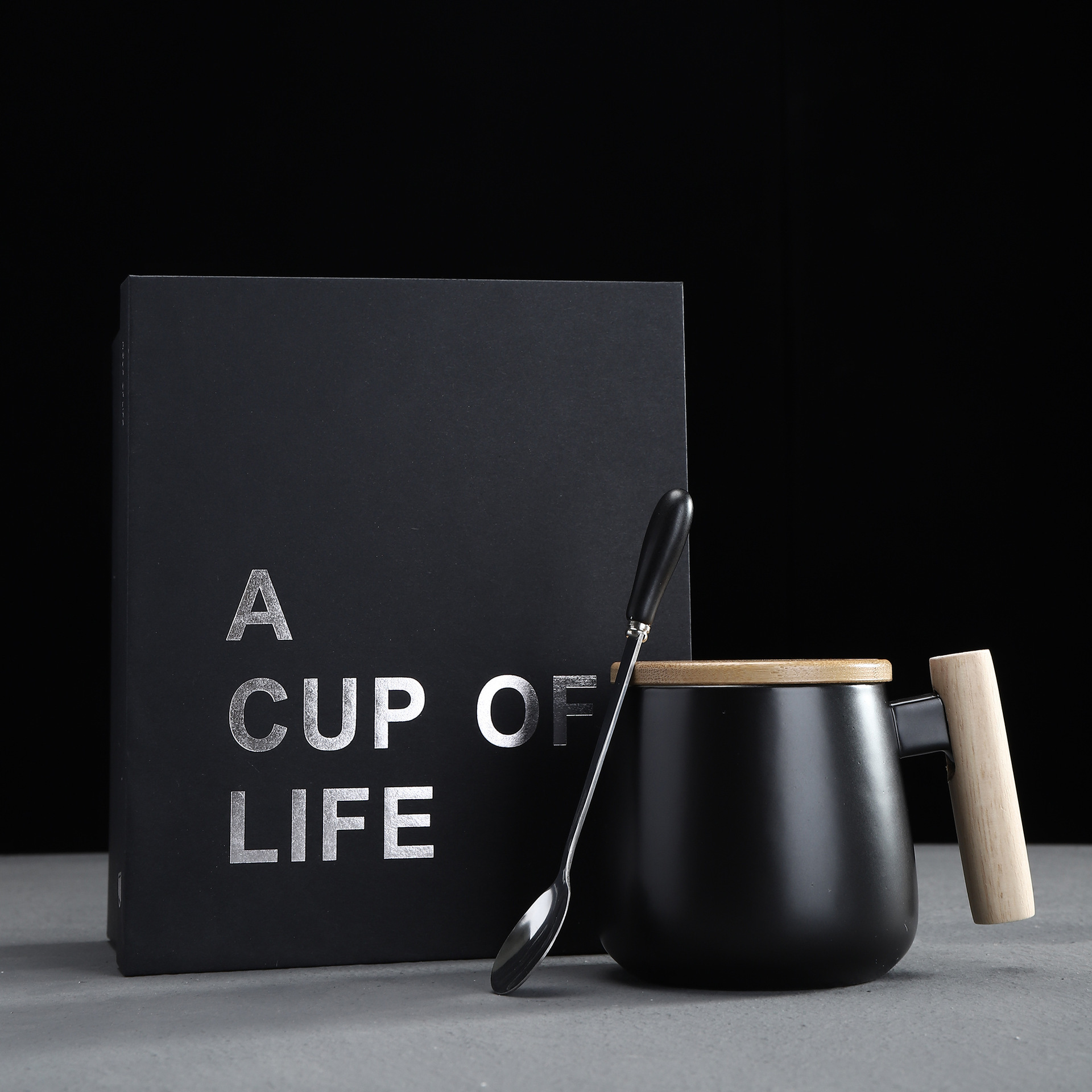 black mug with lid, spoon and gift box