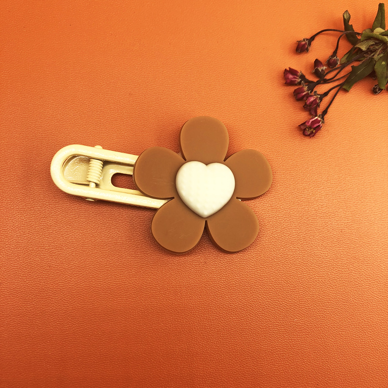 Brown hair clip with white heart