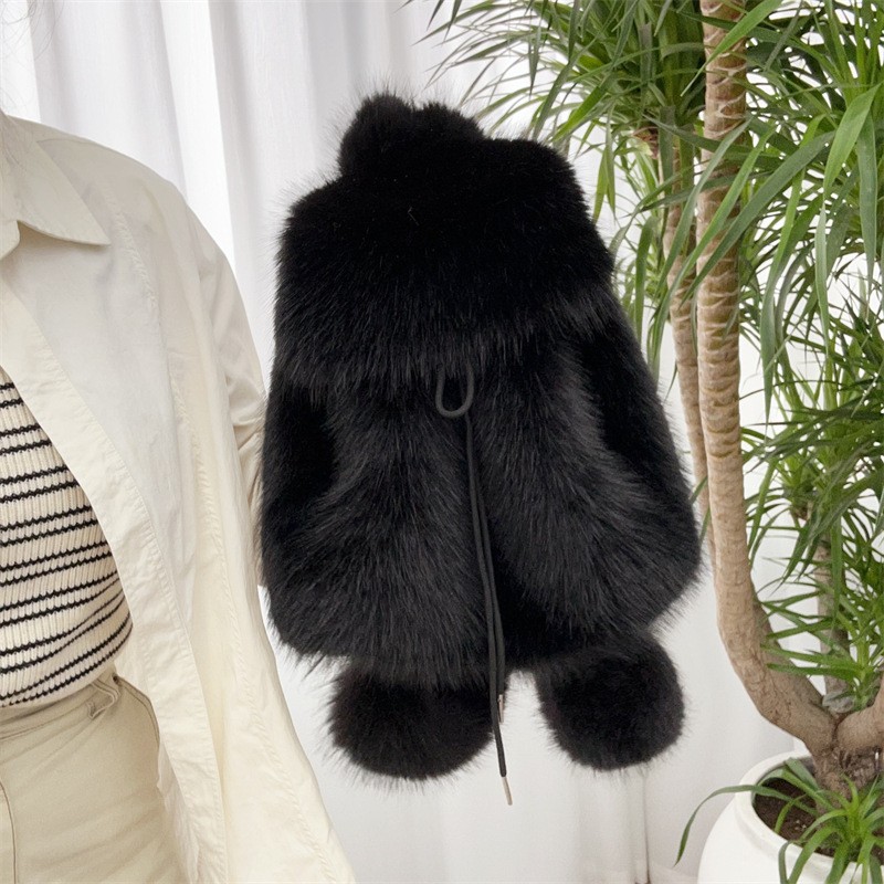 The fur shoulder strap imitates fox fur in black