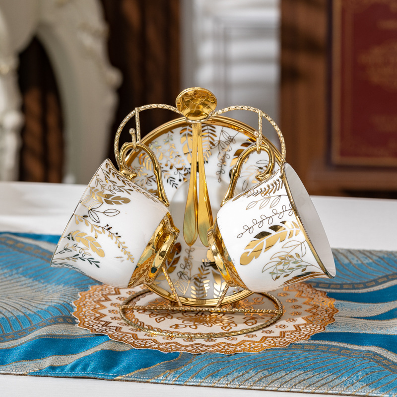 Two cups, two plates and two spoons of golden branches and jade leaves