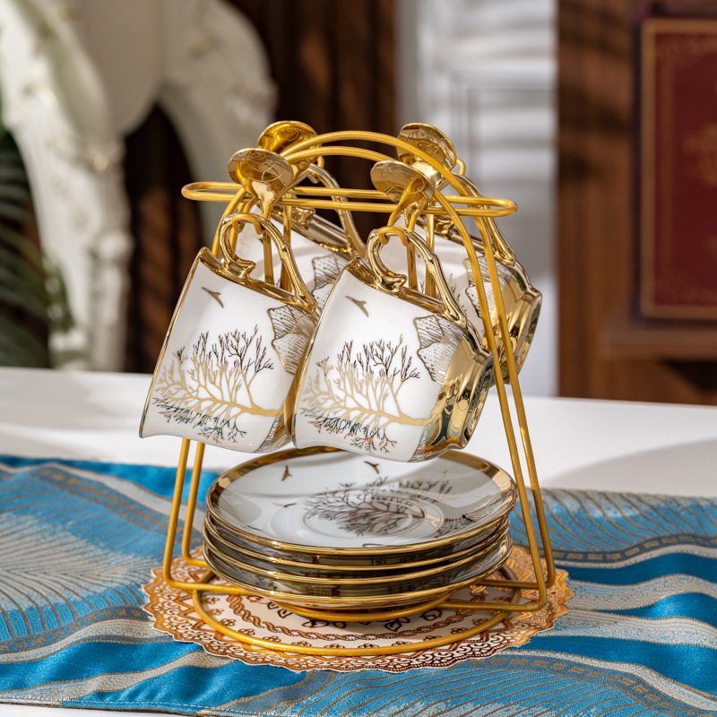 Green trees and golden mountains: 4 cups, 4 plates, and 4 spoons