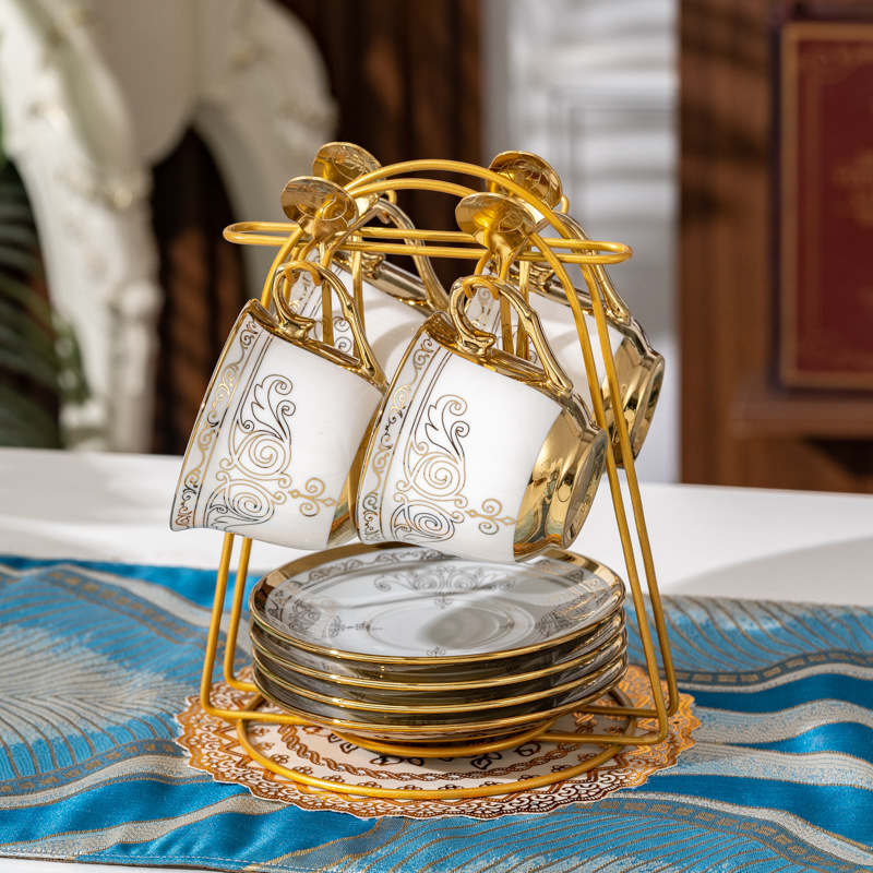 Golden crown, 4 cups, 4 plates, golden spoon