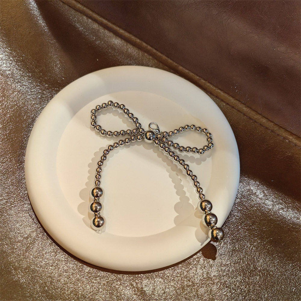 Medium silver bead bow shoe flower string