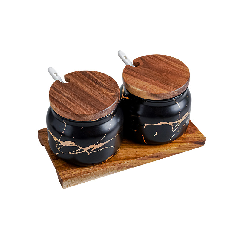 Set of two matte black marble gold round seasoning jar with ceramic spoon and wooden holder