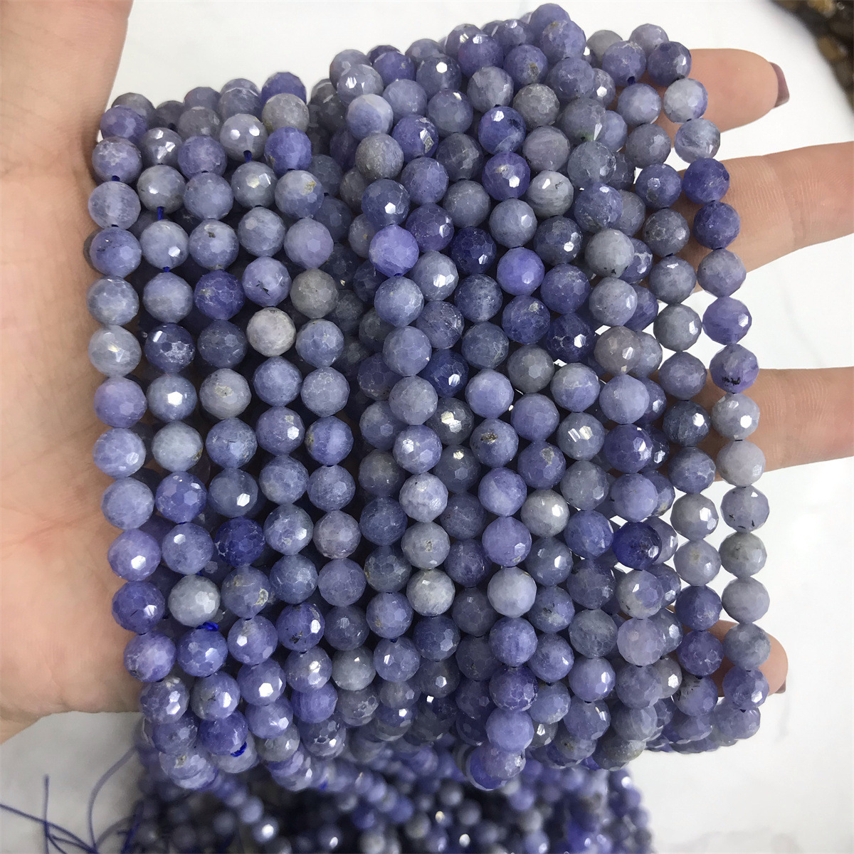 07-6mm tanzanite 5-6mm faceted round beads, one pi