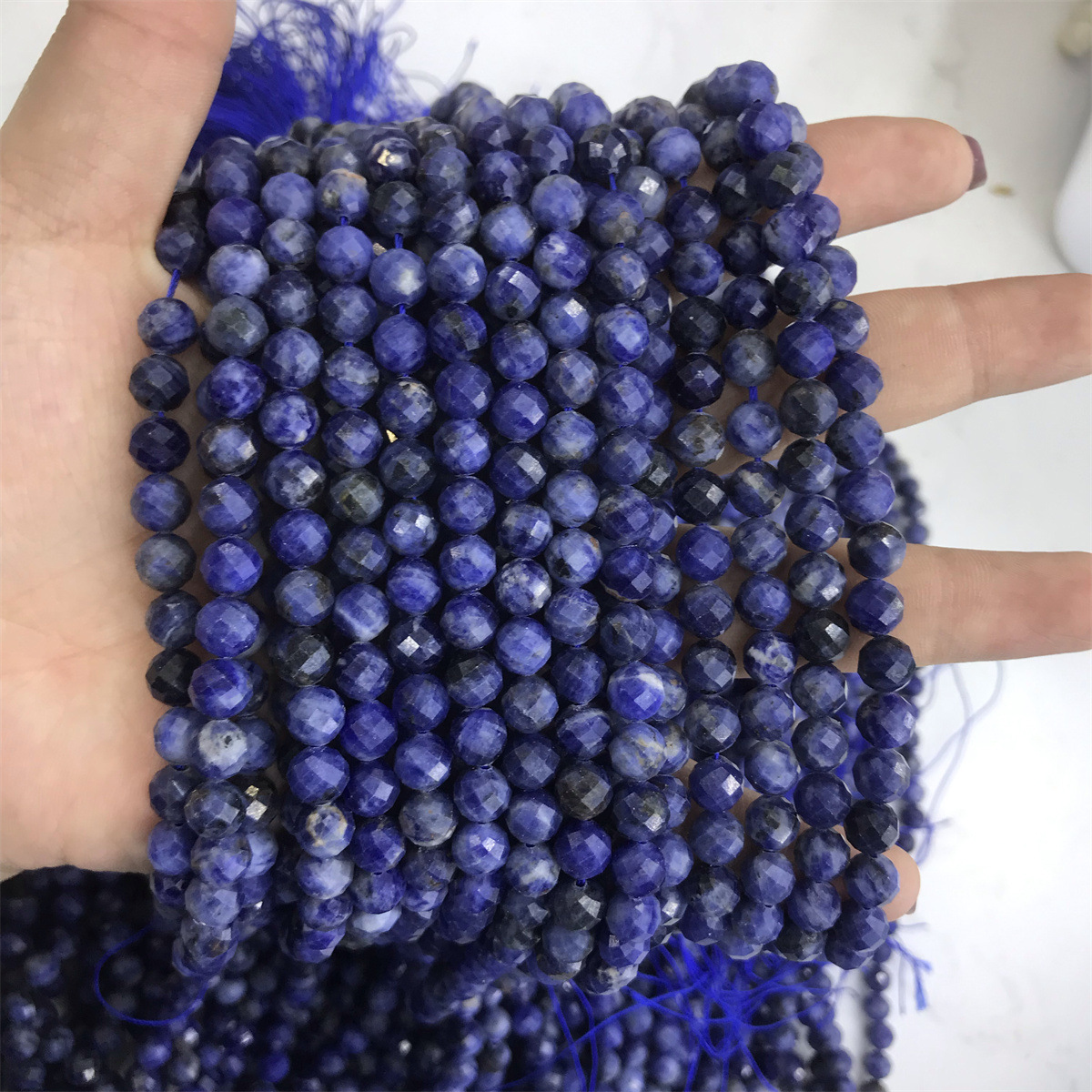 14-6mm blue stone 5-6mm faceted round beads, one p