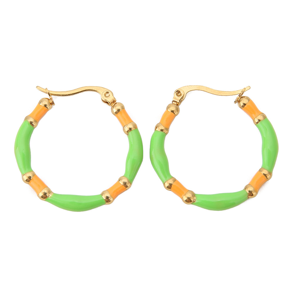 The grass is green and the orange is yellow