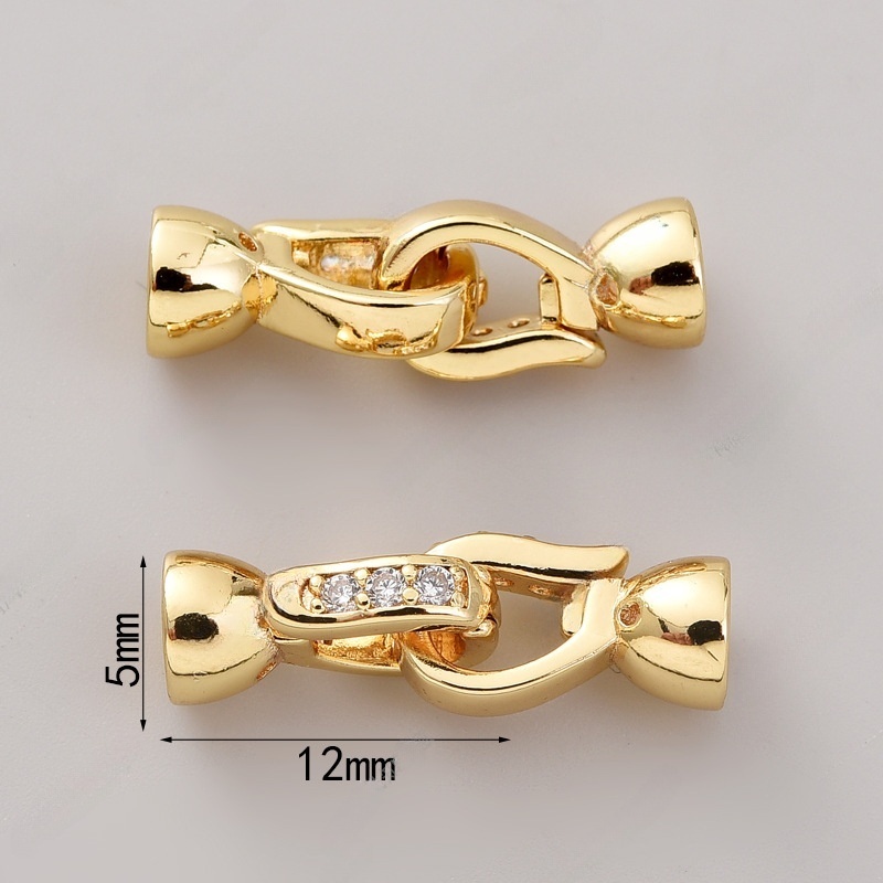 # 1293 pair of 18k gold zirconium buttons (two)